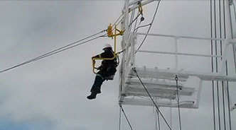 An oil worker escapes "danger" from a service rig in this Ride Inc emergency egress demonstration